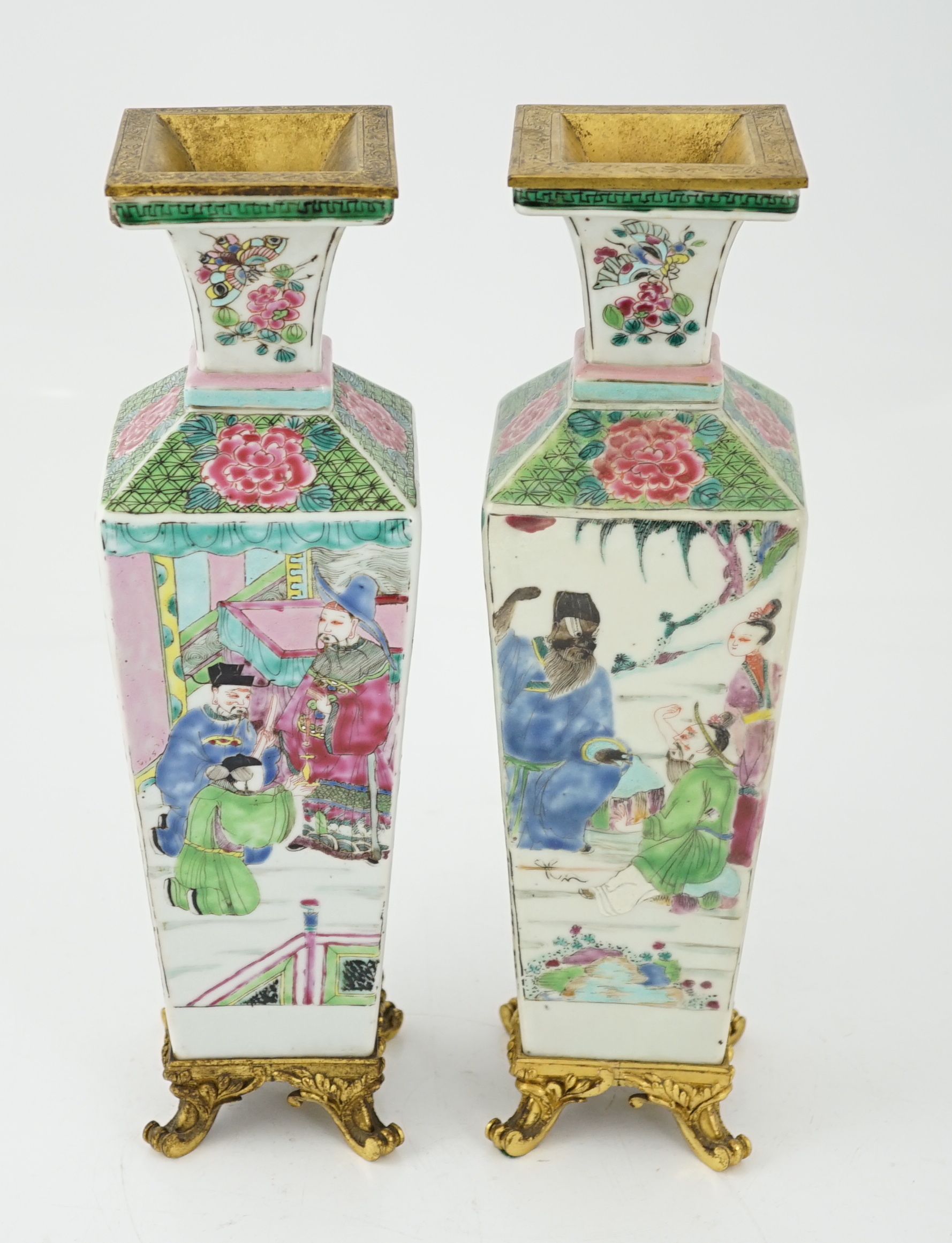 A pair of Chinese famille rose square baluster vases, late 19th/early 20th century, with European gilt metal mounts, each painted with figure scenes, total height 32cm